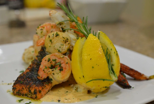 Blackened herb crusted salmon topped with scallops & shrimp and a lemon cream sauce