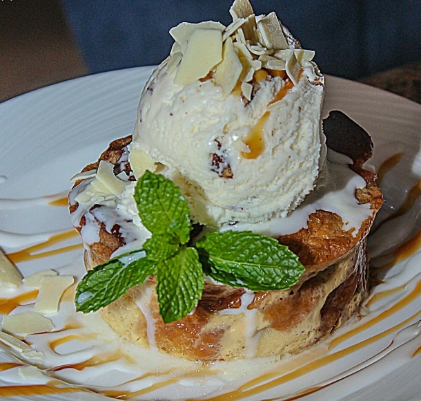 Krispy Kreme Doughnut Bread Pudding topped with vanilla ice cream, and mint