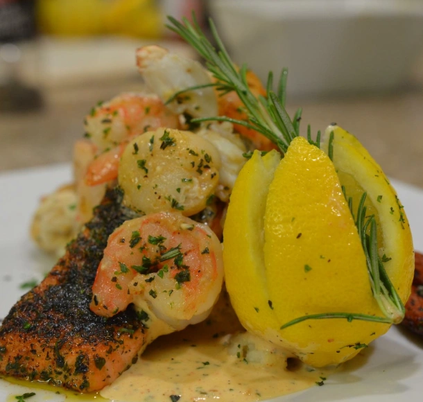 Blackened herb crusted salmon topped with scallops & shrimp and a lemon cream sauce